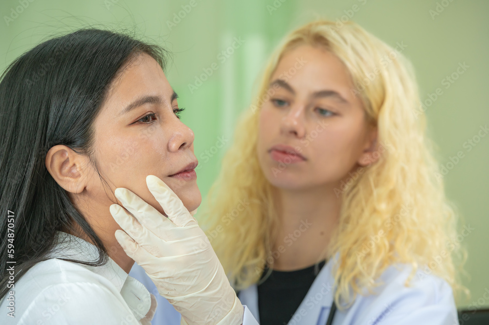 Woman Doctor Gently use hand syringe careful inject iller Botox liquid through skin patient for cosmetic beauty at cosmetic surgery department in hospital clinic. Woman Doctor Gently use hand syringe careful inject iller Botox liquid through skin patient for cosmetic beauty at cosmetic surgery department in hospital clinic.