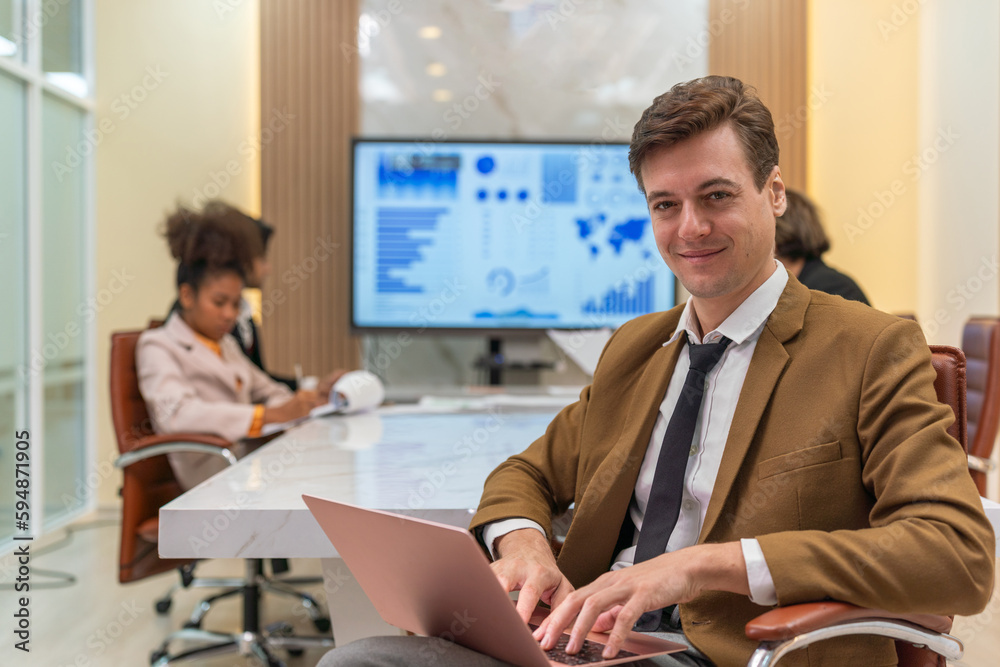 Young handsome successful businessman with different poses in a meeting room. Team lead in a meeting room. Manager at work.