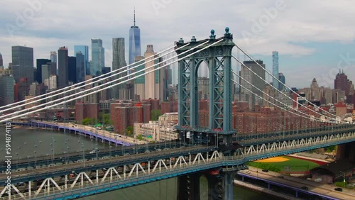 Cinematic Aerial of Manhattan Bridge with over east river   and FDR drove with Brooklyn Bridge and famous New York City buildings in background  downtown NYC and traffic across 
