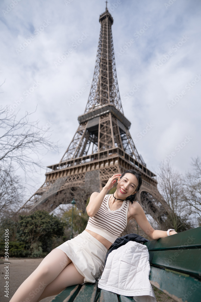 Woman near the Eiffel tower Paris, France.