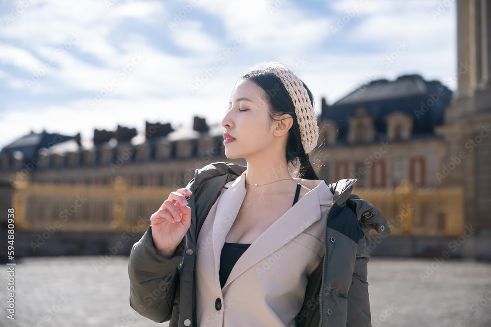 Fototapeta premium Woman posing at the Palace of Versailles outdoor in Paris, France.
