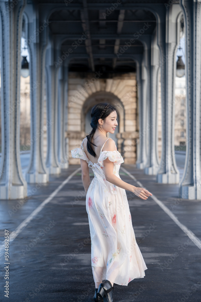 woman portrait under Bir Hakeim bridge with Eiffel tower. Paris, France.