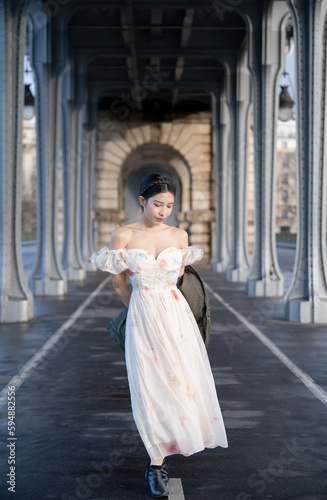 woman portrait under Bir Hakeim bridge with Eiffel tower. Paris, France.