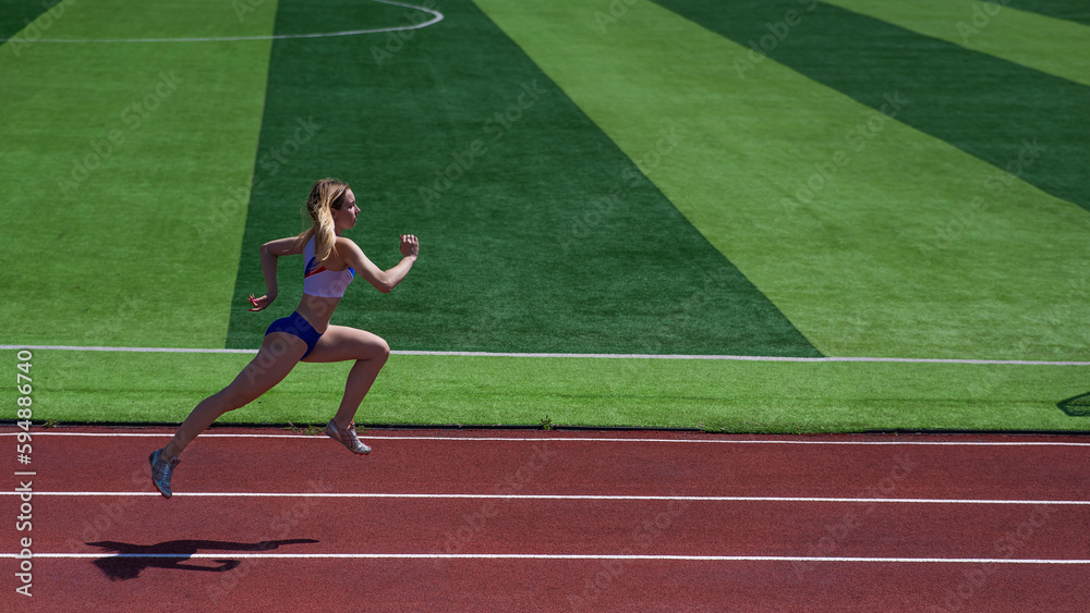 Obraz premium Young caucasian woman is engaged in jogging at the stadium outdoors.