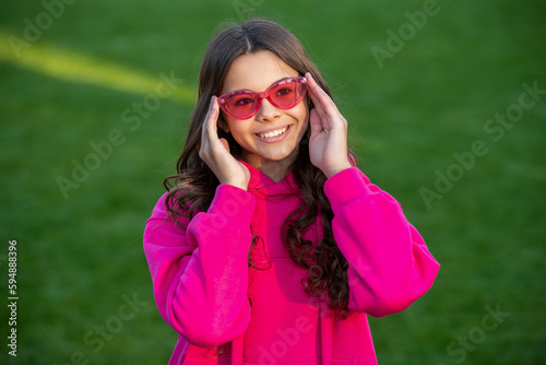 positive stylish teen girl wear glasses. photo of stylish teen girl wear hoodie. © be free