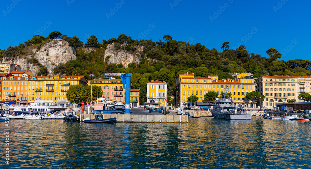 Nice port with yachts, boats and pierces in Nice Port and yacht marina district with Colline du Chateau Castle hill on French Riviera in France