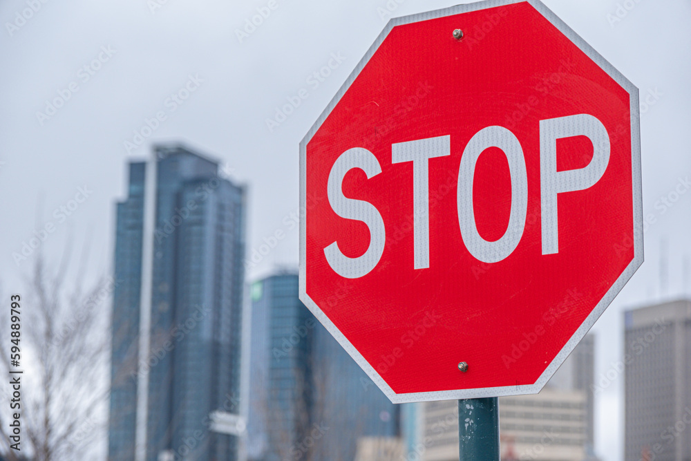 Stop sign with winnipeg Manitoba skyline in background