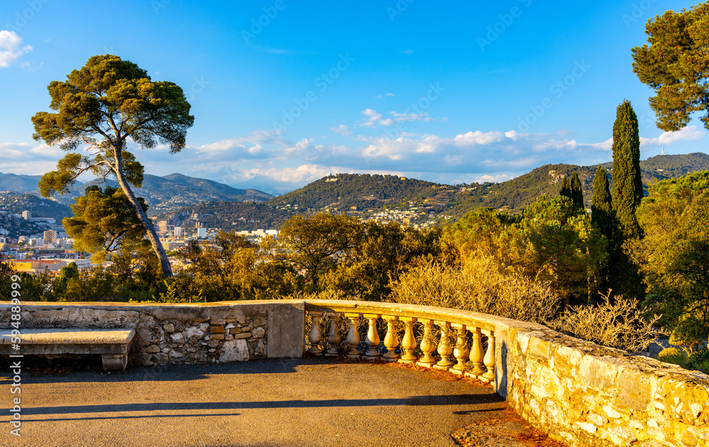 Sunset view of Colline du Chateau Castle Hill landscape terrace and Tour Bellanda Tower in Nice over French Riviera of Mediterranean Sea in France