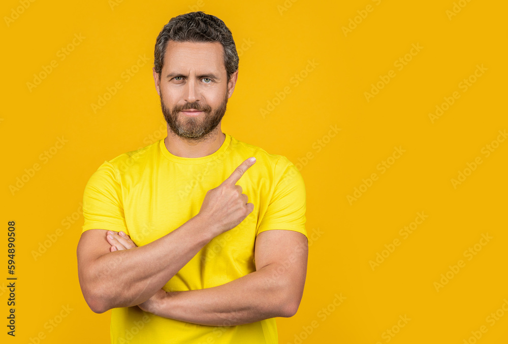 man pointing finger at advertisement offer. man pointing at advertisement offer in studio. man pointing finger at advertisement offer. man pointing at advertisement offer in studio.