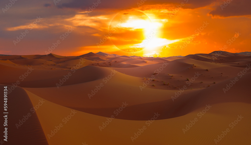 Beautiful sand dunes in the Sahara desert at sunrise with solar eclipse  - Sahara, Morocco