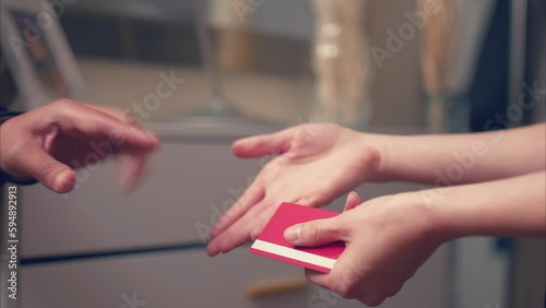 Caucasian Woman Offering Payment, Latino Male Declining Credit Card. Shot with ARRI Alexa in ARRIRAW and exported QuickTime Apple ProRes 422 HQ. photo