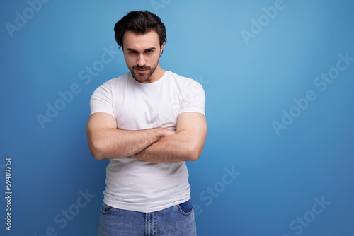 confident strong brunette man in white tank top with muscles © Ivan Traimak