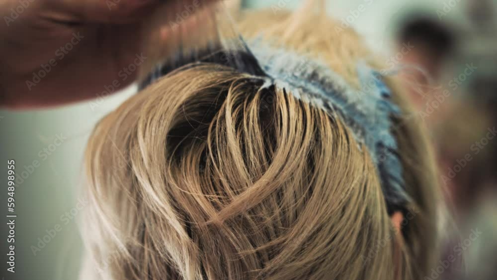 hair coloring in blonde. beauty salon. male barber's hands. close up hair coloring in blonde. beauty salon. male barber's hands. close up