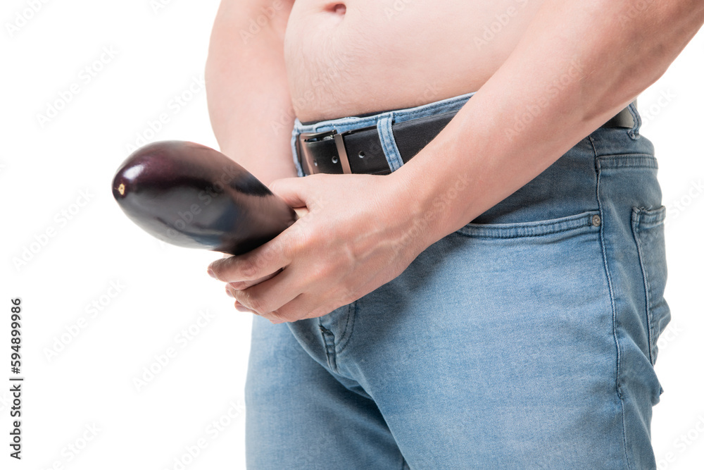 Guy crop view holding eggplant at crotch level imitating penis potency  isolated on white Stock Photo