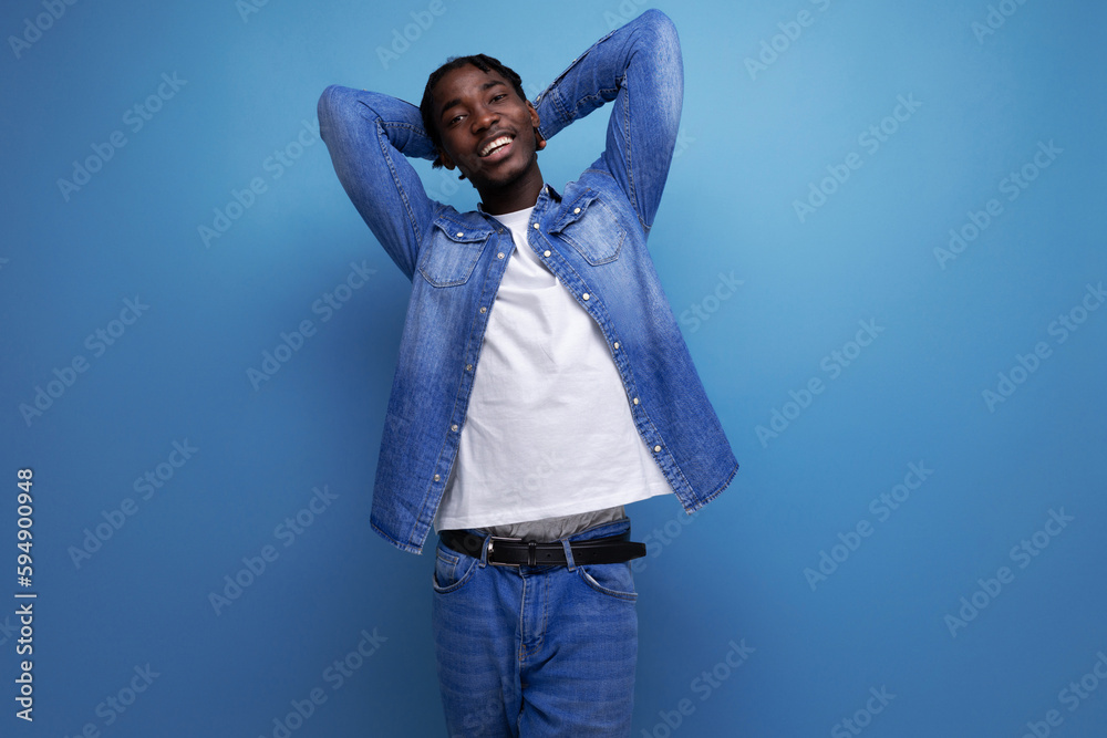 confident african young man with dreadlocks shows that everything will be ok