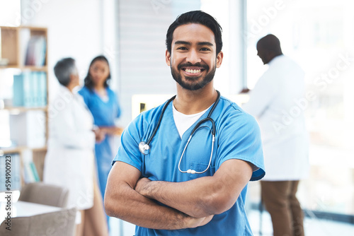 Medical, arms crossed doctor with portrait of man for healthcare, surgery and happy. Smile, medicine and confident with male nurse standing in hospital for wellness, cardiology and expert