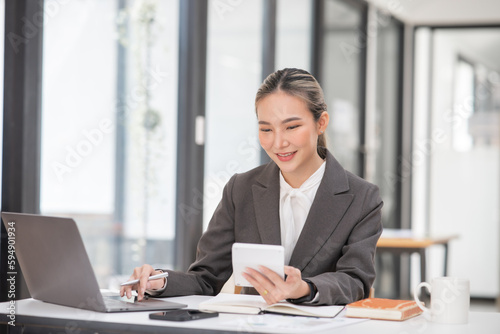 Young Asian businesswoman working on documents at office