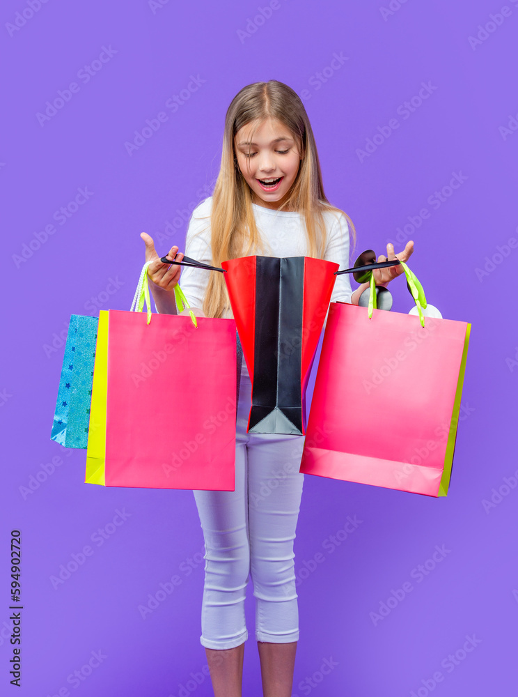 amazed teen girl with shopping purchase in studio. teen girl with shopping purchase amazed teen girl with shopping purchase in studio. teen girl with shopping purchase