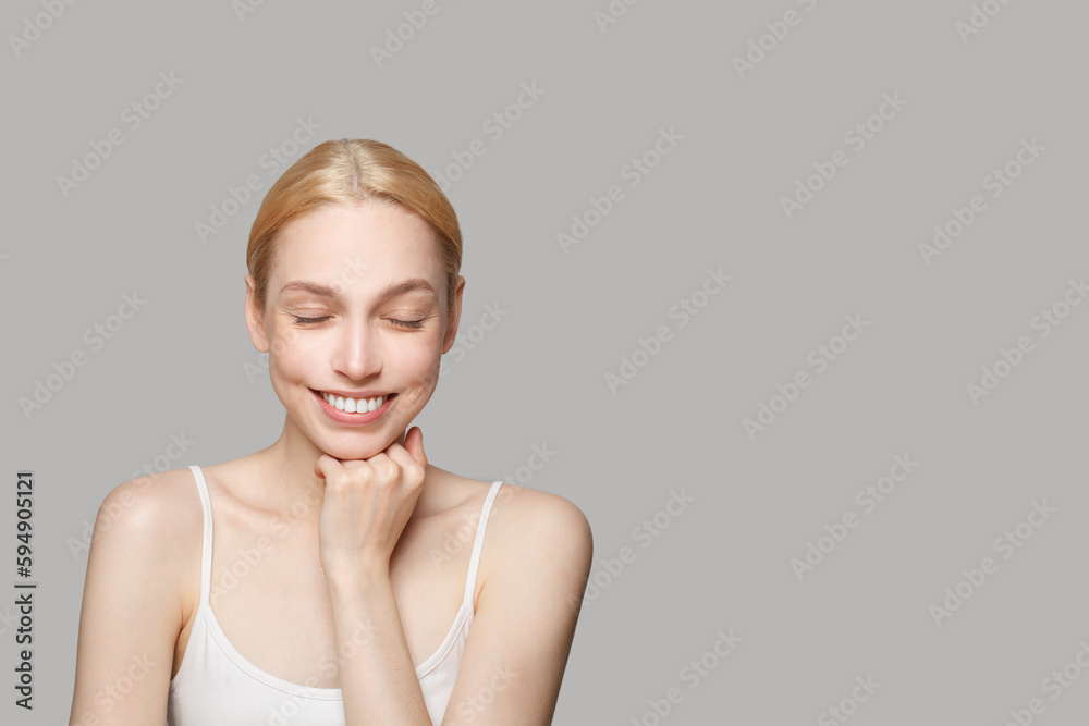 Happy cheerful model with cute smile. Healthy woman with fresh skin posing with closed eyes. Facial treatment, skincare and cosmetology concept Happy cheerful model with cute smile. Healthy woman with fresh skin posing with closed eyes. Facial treatment, skincare and cosmetology concept