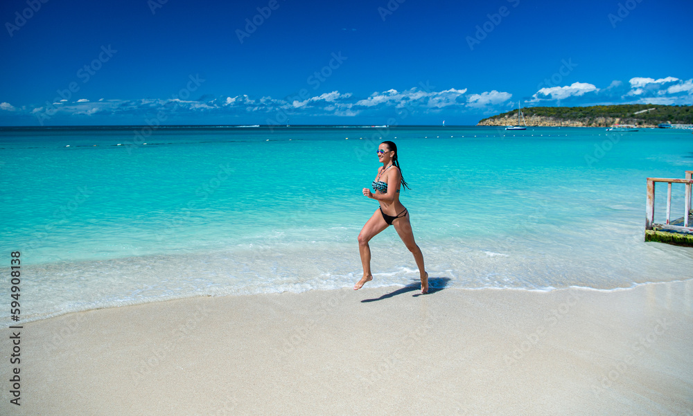 photo of woman running on summer vacation. woman running on summer vacation at beach.