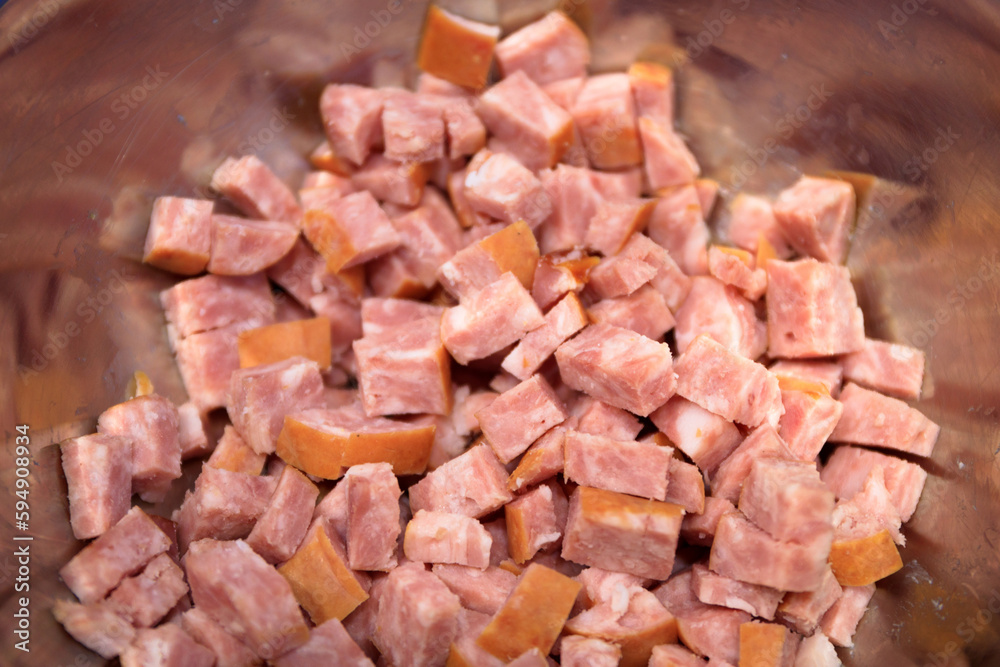 Sliced sausage in a bowl as an ingredient of the dish