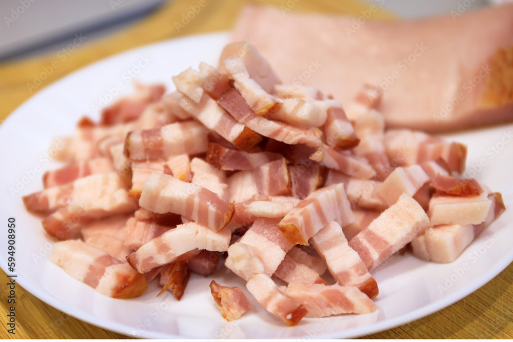 Sliced bacon on a plate ready for frying Sliced bacon on a plate ready for frying