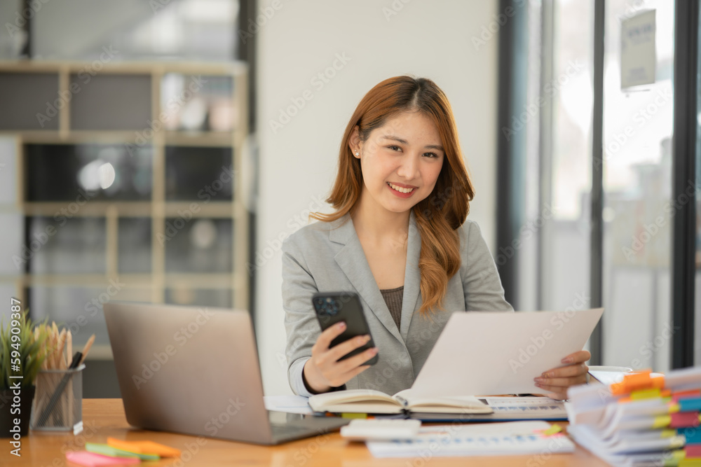 Asian businesswoman holding notebook about business, spending money