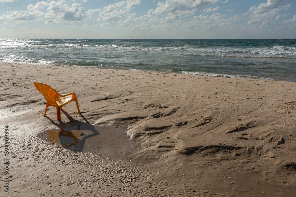 Plastic chair on sunny wet, sandy ocean beach, Bat Yam, Israel
Plastic chair on sunny wet, sandy ocean beach, Bat Yam, Israel