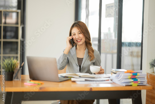 Wallpaper Mural Asian businesswoman holding notebook about business, spending money Torontodigital.ca