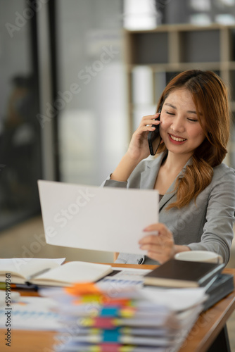 Asian businesswoman holding notebook about business, spending money