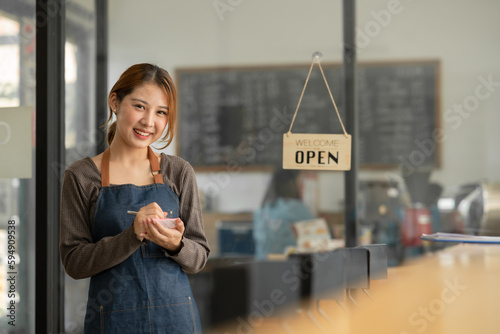 Asian female employees greet customers at a coffee shop.