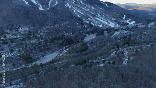 Aerial cinematic drone forward pan reveal  t  Loon Mountain Resort and mountain village town, New Hampshire photo