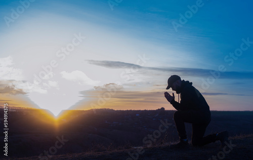 Prayer. A man prays on his knees. Repentance for sins. Kneeling