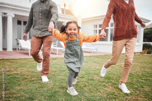 Child, new home and parents playing in portrait and outside for house bonding together on lawn or grass feeling excited. Holding hands, mother and father with little girl, kid or daughter having fun