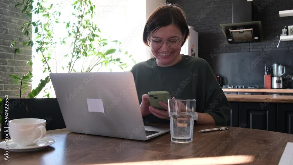 Woman work with laptop at home at kitchen interior. Freelancer at home office. Woman work with laptop at home at kitchen interior. Freelancer at home office.