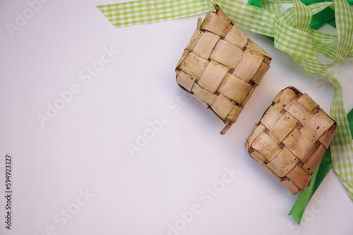 Ketupat, diamond shape steamed rice on white background. Space for text. photo