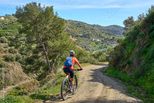 nice senior woman cycling with her electric mountain bike in the Sierra de Tejada near Nerja, Andalusia, Spain © Uwe