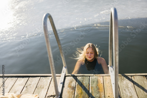 Woman swimming in lake at winter