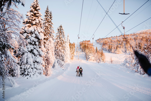 View of skiers on ski lift photo