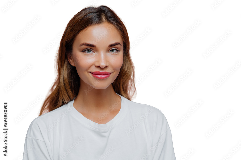 Pretty young woman uses cosmetics for looking young and beautiful, has long hair, looks confidently at camera with happy tender smile, wears casual outfit, poses over purple wall, blank space on right Pretty young woman uses cosmetics for looking young and beautiful, has long hair, looks confidently at camera with happy tender smile, wears casual outfit, poses over purple wall, blank space on right