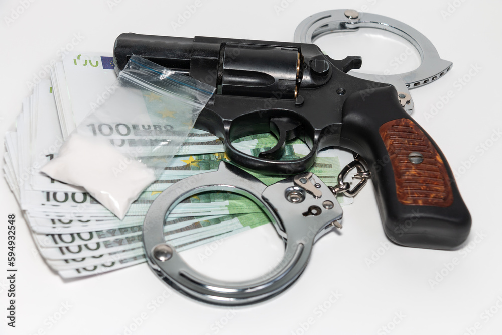Revolver, euro, handcuffs and a bag of white powder on a white background. The concept of punishment for the manufacture and sale of drugs.