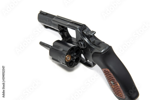 One cartridge in the drum of a revolver on a white background. Russian roulette is a revolver with one cartridge in the cylinder. Close-up.