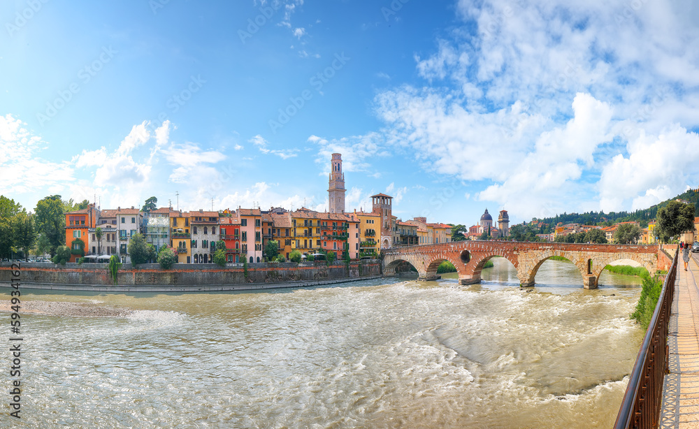 Astonishing Verona cityscape view on the riverside with historical buildings ,bridges and tower