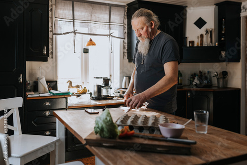 Man preparing food in kitchen photo