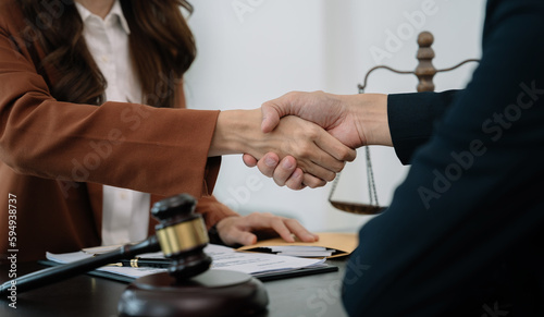 partner lawyers attorneys shaking hands after discussing a contract agreement done.