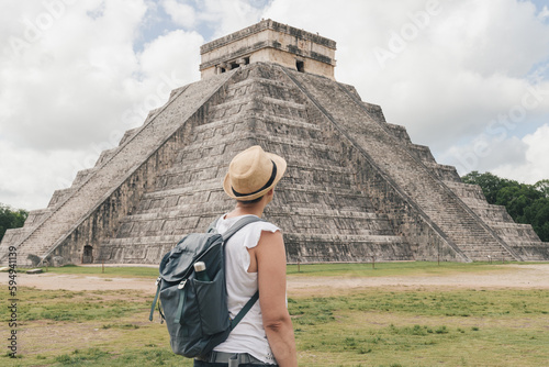 Woman with hat and backpack in the pyramid of Kukulcan in the Mexican city of Chichen Itzá, travel concept