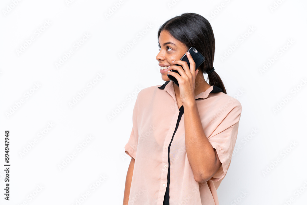 Young African american woman isolated on white background keeping a conversation with the mobile phone with someone Young African american woman isolated on white background keeping a conversation with the mobile phone with someone