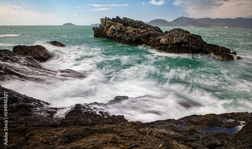 Waves flowing around the coastal sea rocks