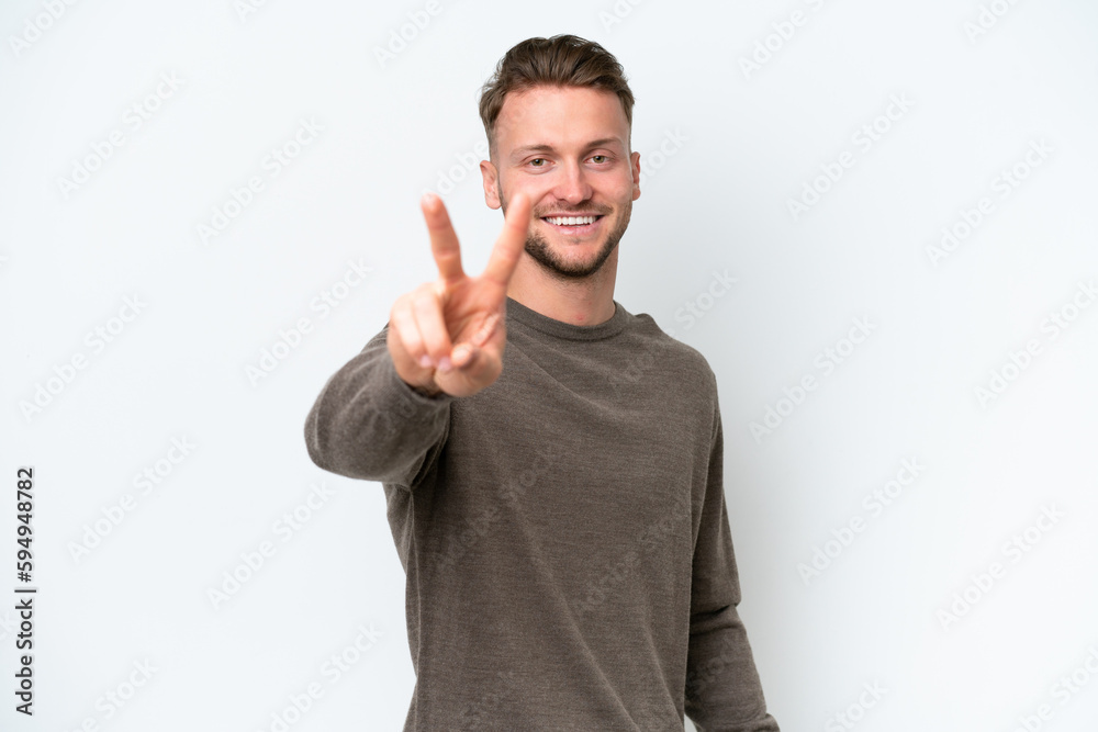 Young blonde caucasian man isolated on white background smiling and showing victory sign Young blonde caucasian man isolated on white background smiling and showing victory sign