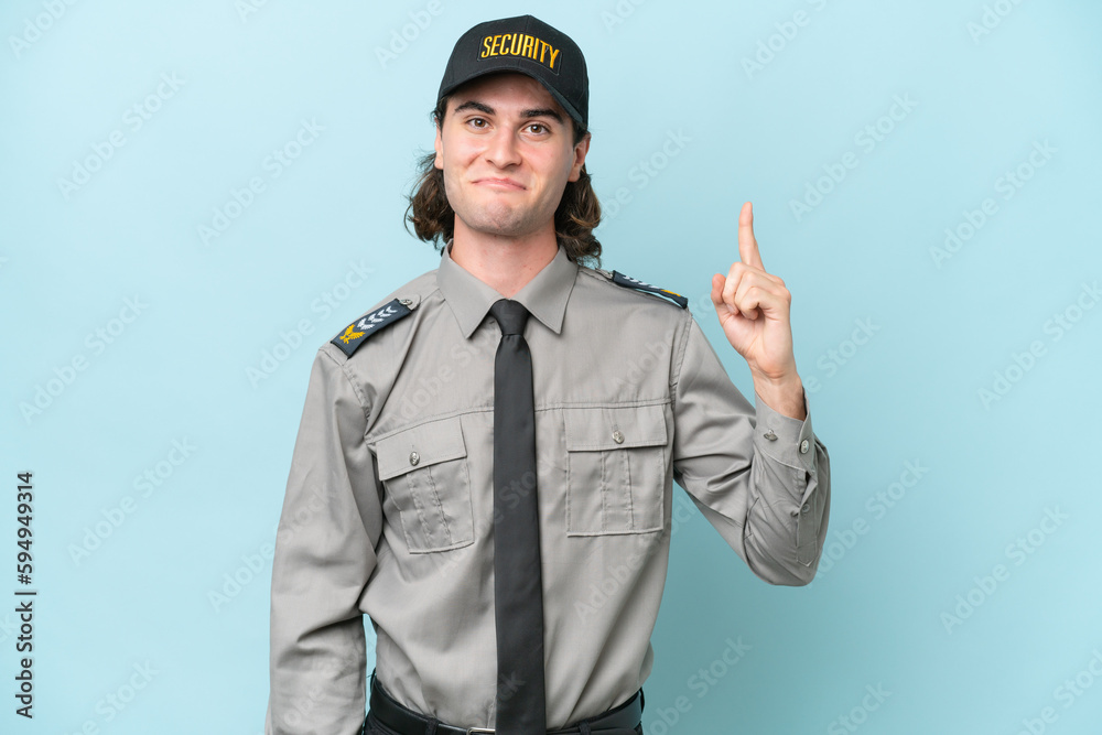 Young safeguard man isolated on blue background pointing with the index finger a great idea Young safeguard man isolated on blue background pointing with the index finger a great idea